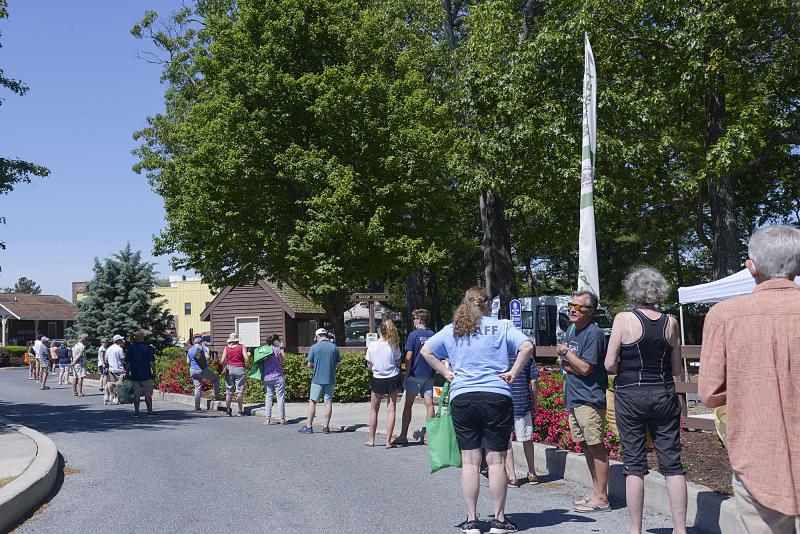 The line to get into the market is respectfully distanced.
